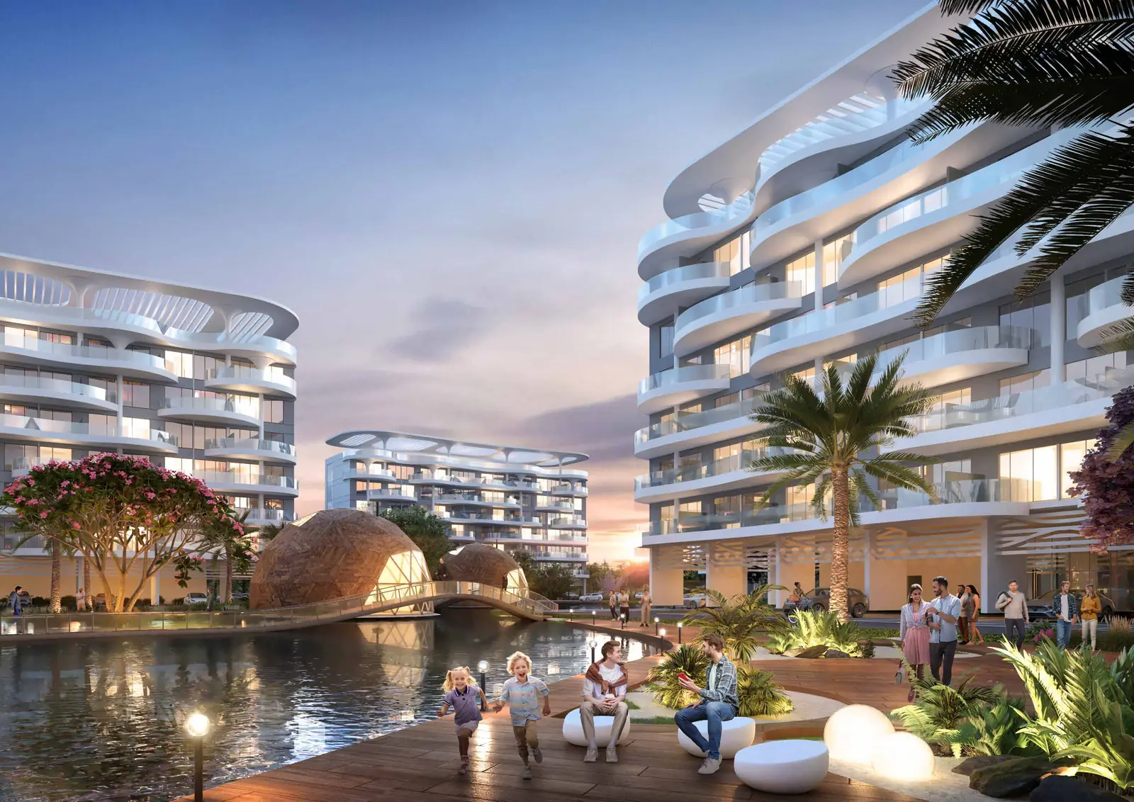 DAMAC Lagoon Views buildings at dusk beside the lagoon